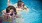 a couple of kids in a swimming pool