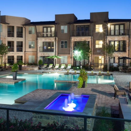 a swimming pool with lush landscaping
