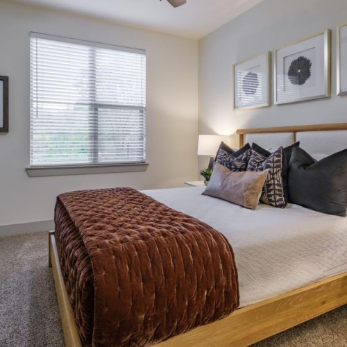 a bedroom with a bed and a fan