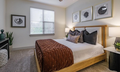 a bedroom with a bed and a fan