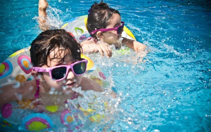 a couple of kids in a swimming pool