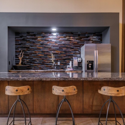 a bar with stools and a large oven