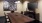 a conference room with a large round table and chairs